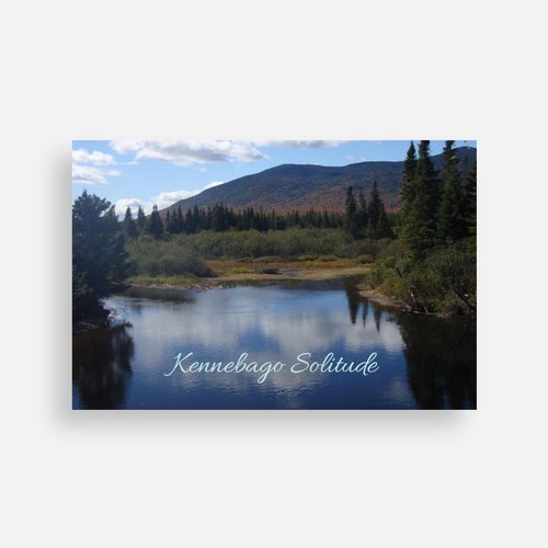 Scenic postcard showing a quiet lake with mountains and pine trees