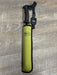 A REC brand wading staff with a black handle and retractor,  with a green protective sleeve on a gray wood-look floor.