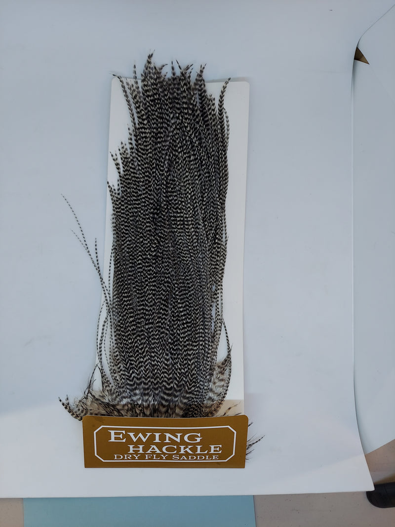 Ewing Hackle dry fly saddle on card, dark grizzly feather fibers