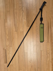 Black wading staff with attached green pouch and shoulder strap