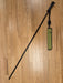 The REC black wading SureStaff extended lying on a light brown floor with its Sheath