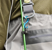Gray jacket zipper panel with green cord and carabiner clip