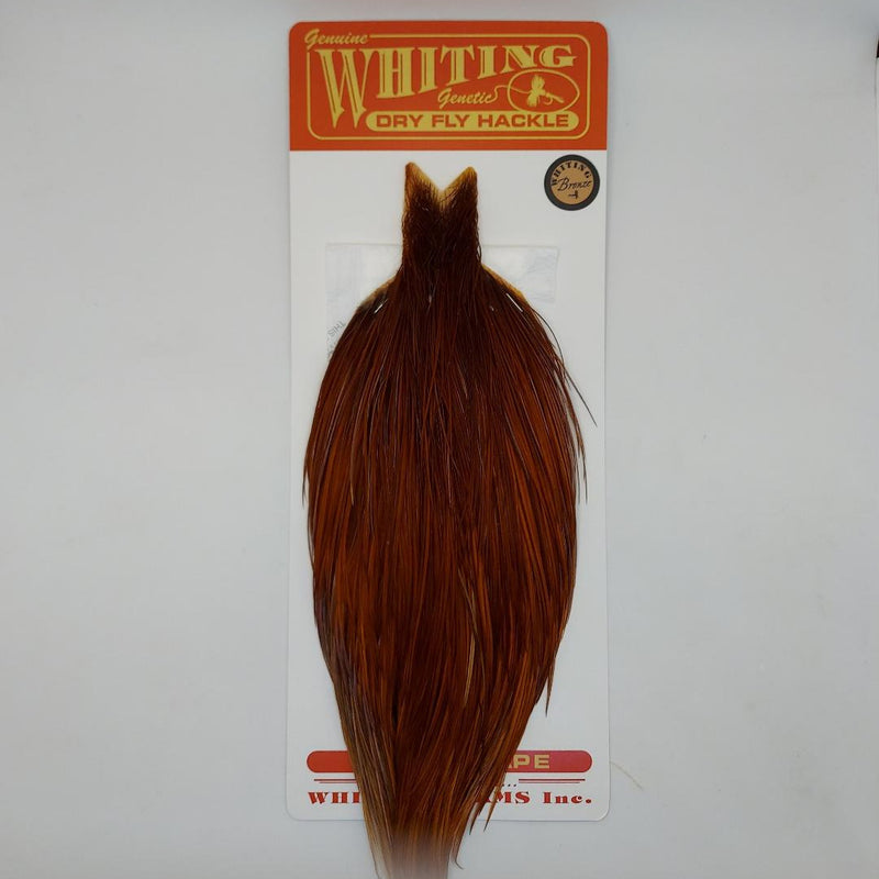Brown bronze feather cape with tapered top and long fibers on display card