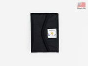 Foldable stash bag in dark gray with black trim and label patch