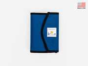 Foldable stash bag in blue with black trim and white label patch
