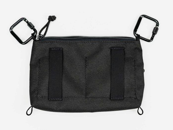 Utility pack with black fabric, two front loop tabs and webbed pocket sections
