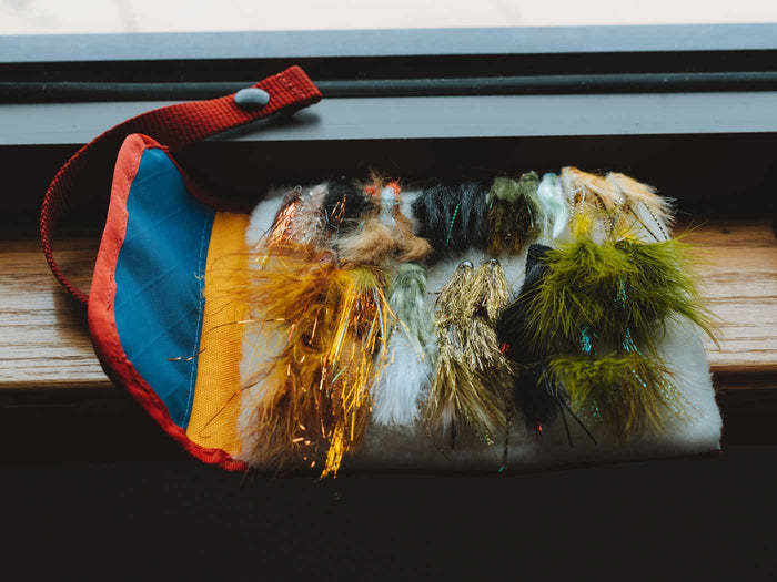 Streamer stash roll holding colorful fur streamers with blue and yellow fabric