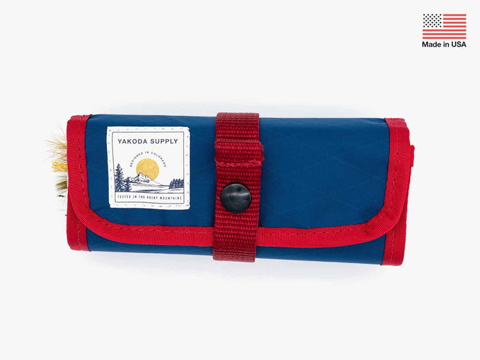 Streamer stash roll with blue fabric and red strap, snap button flap