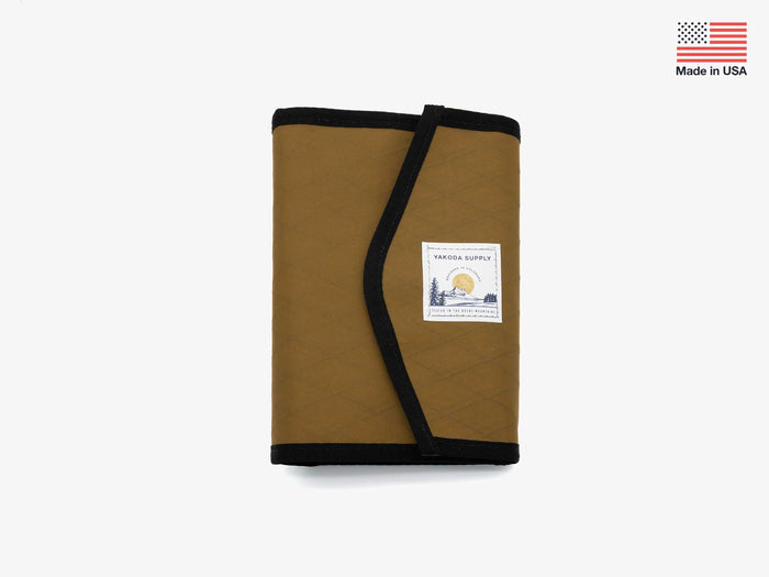Foldable stash bag in coyote-brown with black trim and label patch