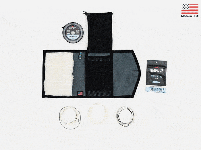 Foldable stash bag with black exterior, open top, white interior lining and rings