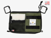 Utility pack with olive and black panels, white fur patch, zip pockets and label