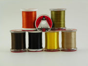 70 denier thread spools in black, olive, tan, and orange with labels