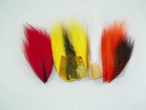 red yellow white and orange bucktail pieces used by fly tyers to create streamer flies