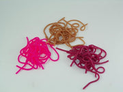Tangle of plastic worm toys in tan, magenta, and dark pink colors.