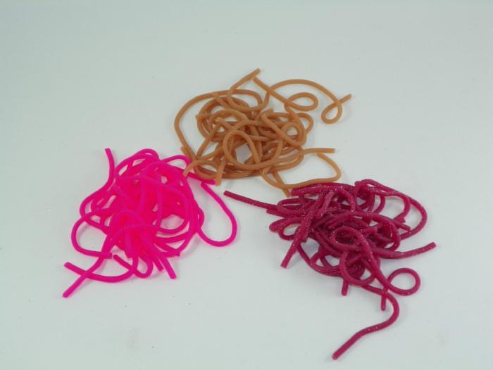 Tangle of plastic worm toys in tan, magenta, and dark pink colors.