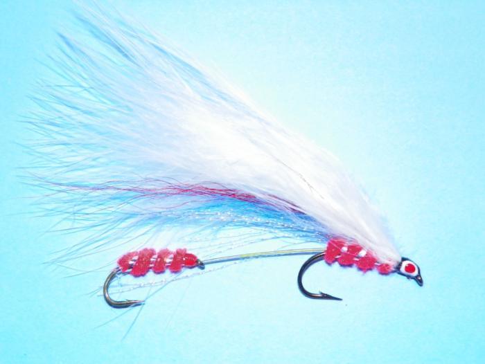 Feather fishing lure with red bead body, blue-white streamer, and two barbed hooks