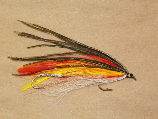 tandem trolling fly with orange and yellow wings topped with peacock and white bucktail underwing tied by Ken Grimes of Fishing Favorites