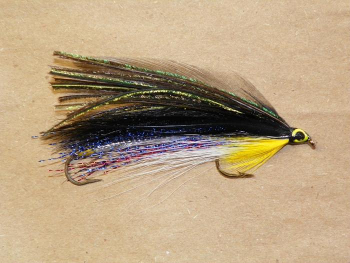 Feathered fishing lure with yellow head, black-green body, and multicolor tail