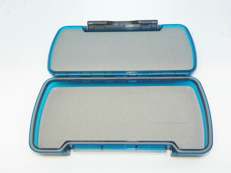 Blue fly box open with clear plastic compartment lid and gray foam insert