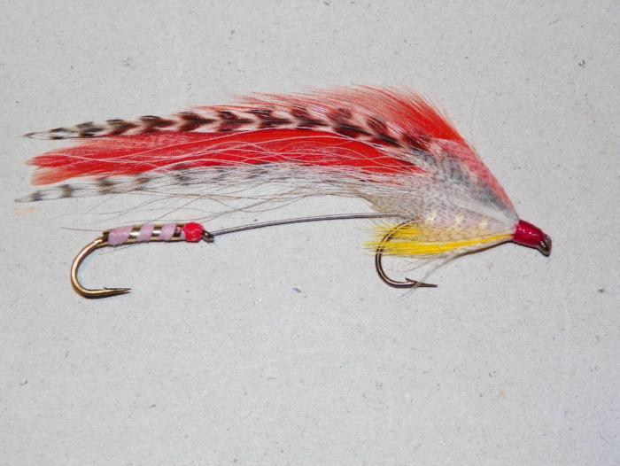 Tandem feather fishing lure with red, white, and pink accents, two hooks
