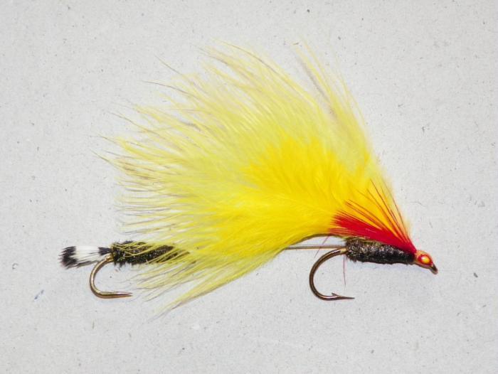 Yellow and red marabou fishing lure with feather tail and two barbed hooks