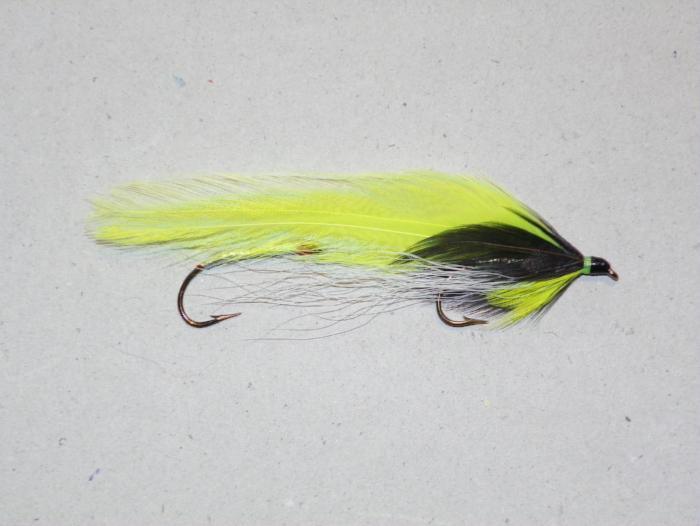 Chartreuse and black feather fishing lure with two treble hooks