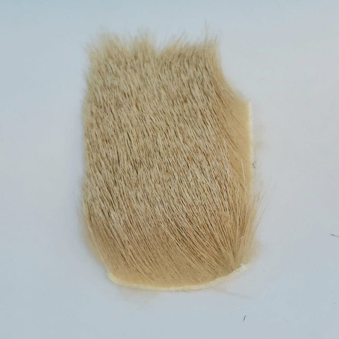 Tan elk hair fiber patch with dense trimmed ends