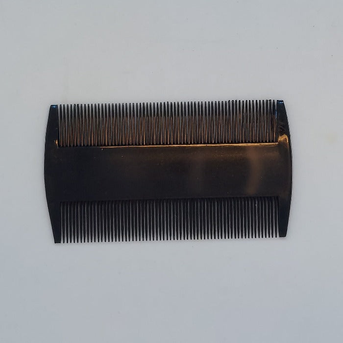 Deer hair comb with dense metal teeth and dark handle