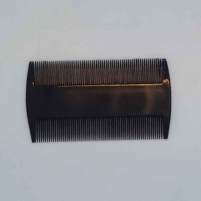 a black double sided deer hair comb  for tying flies
