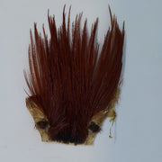 Brown feather fly patch with dark reddish fibers