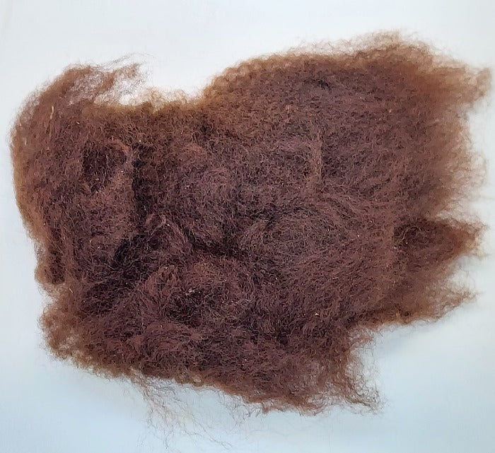 Brown wool tuft with dense shag fibers