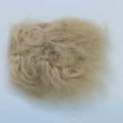 Tan wool tuft with dense shag fibers