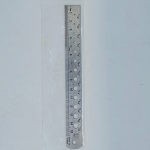 a ruler with holes for measuring the diameter of different beads used in fly tying