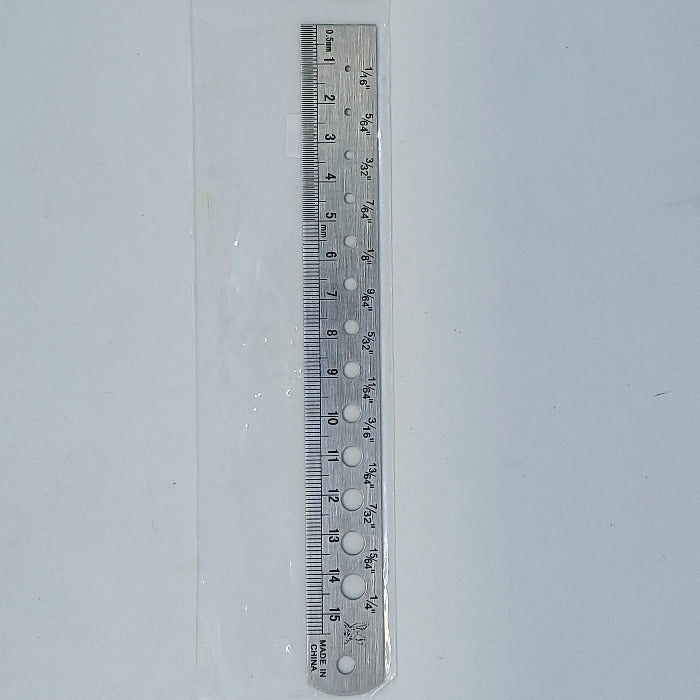 a ruler with holes for measuring the diameter of different beads used in fly tying