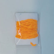 Chenille yarn bundle in bright orange, tightly looped in clear packaging