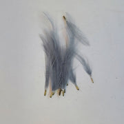 Dry fly tailing feathers in blue-gray with pale yellow bases and forked tips