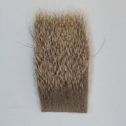 Brown elk hair fiber patch with dense straight edge