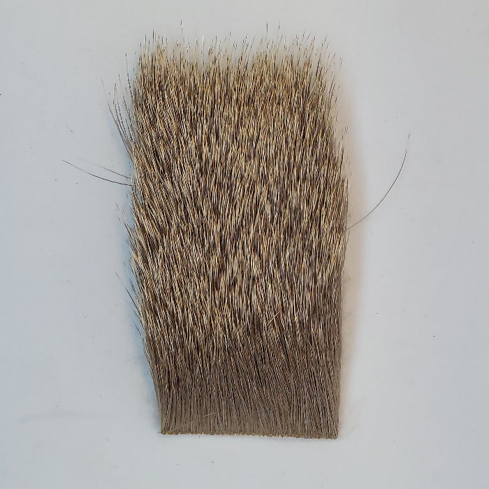 a 2" by 3" piece of natural colored select Cow elk hair used for tying flies