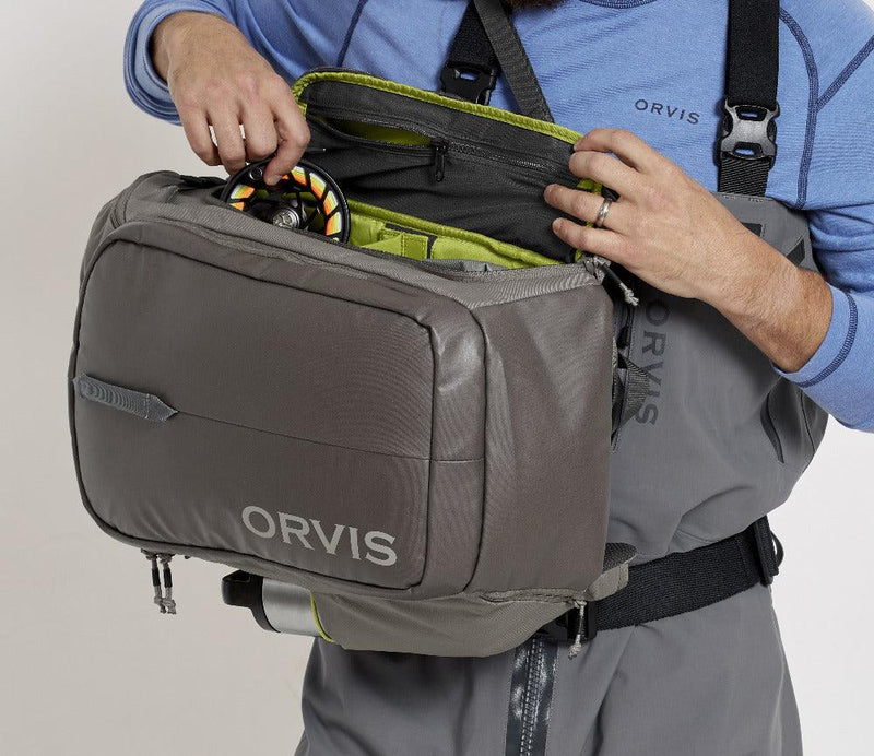 a picture showing how the orvis bug out backpack can be loaded from the side and swung around to the chest for ease