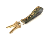 Wingo key fob with dark fabric strap and yellow dot pattern, metal keyring with keys