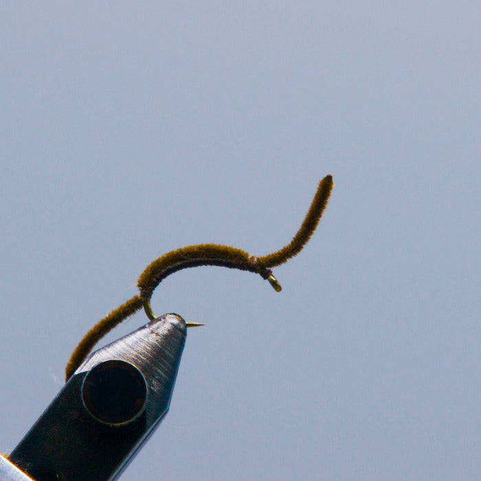 Brown fuzzy fishing worm lure with hook