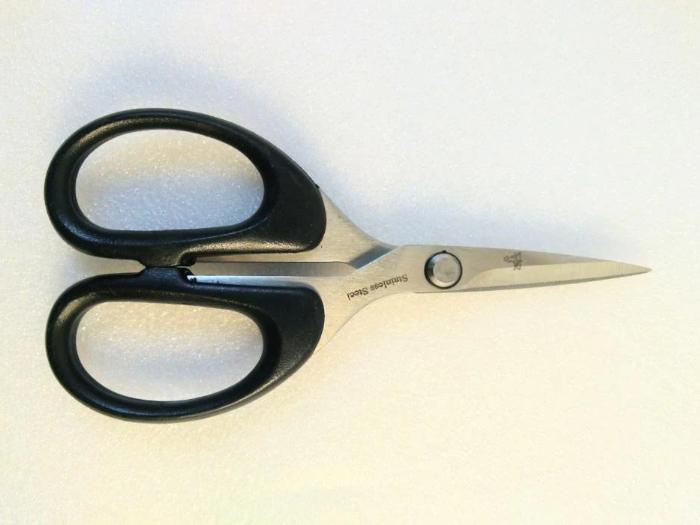 black handled Dr. Slick synthetics 5" scissors  Designed for cutting heavy natural and synthetic materials with Heavy blades with large serrations 