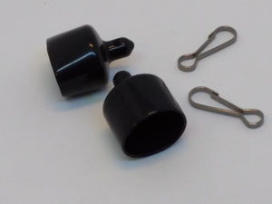 two black rubber caps and attaching clips used to hold floatant, sunscreen, or other itesm
