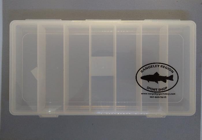 Clear plastic fly box with 7 compartments and round label