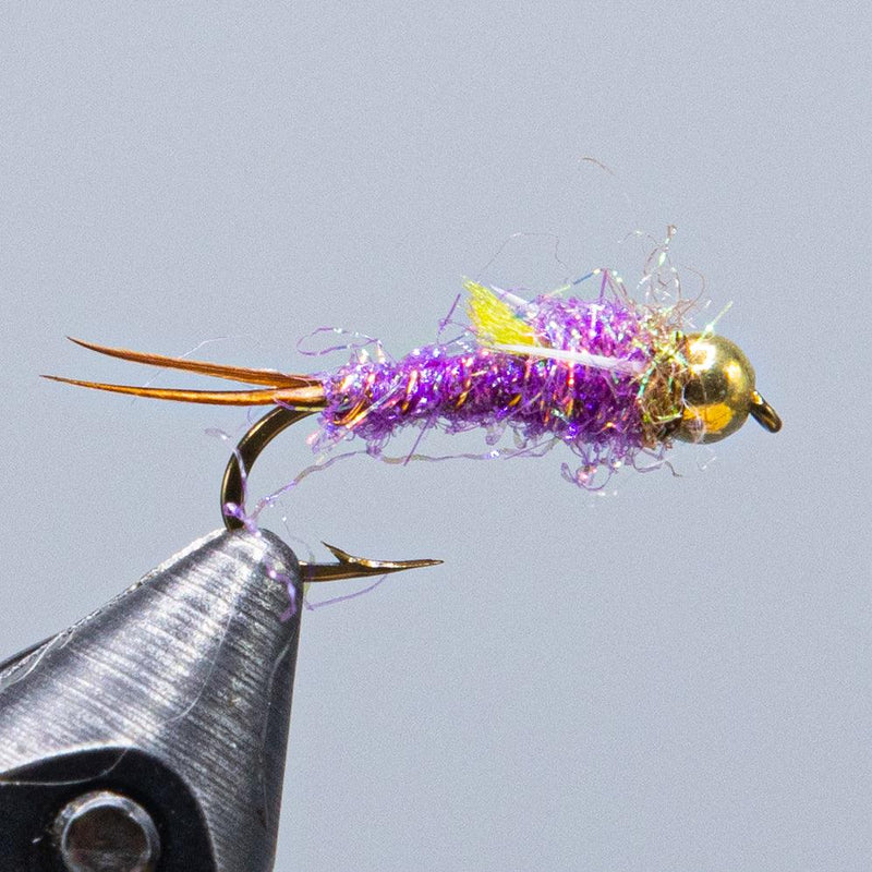 Fishing lure with purple tinsel body, gold bead head, and double hooks