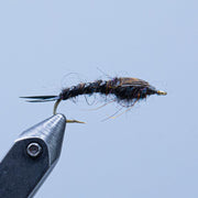 Stonefly fly fishing lure with dark blue-black body and fuzzy wings