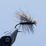 Deer hair caddis fly with dark hair wing and dark body, curved hook