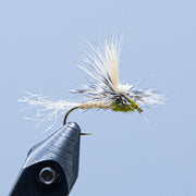 Caddis-style fly with white and tan fibers on curved metal hook