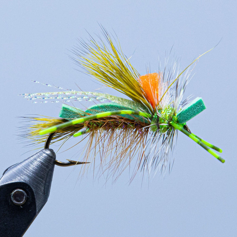Tied foam fly on hook with green foam accents, orange head, and white feathers