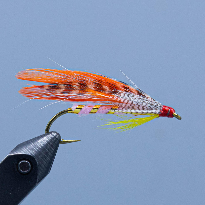 Orange-white feather fishing lure with colorful wing and barbed hook